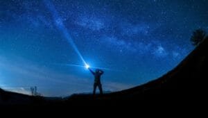 Enhance Immunity silhouette of man holding flashlight
